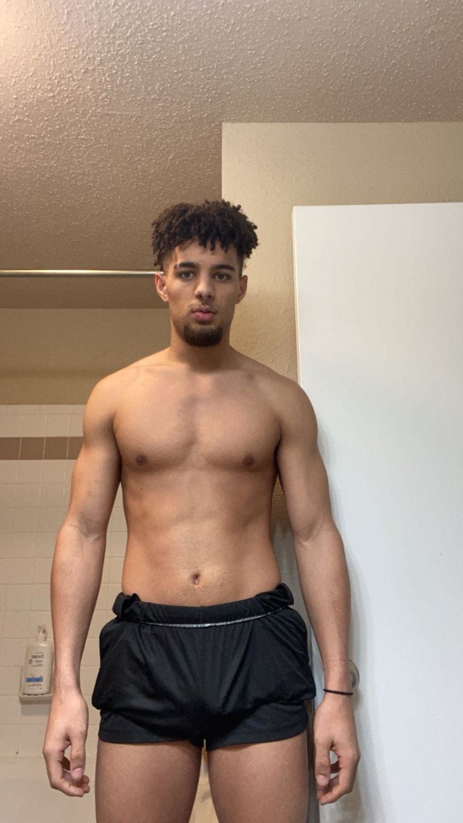 Eli Hughes, direct front-facing physique photo showing his lean, muscular build