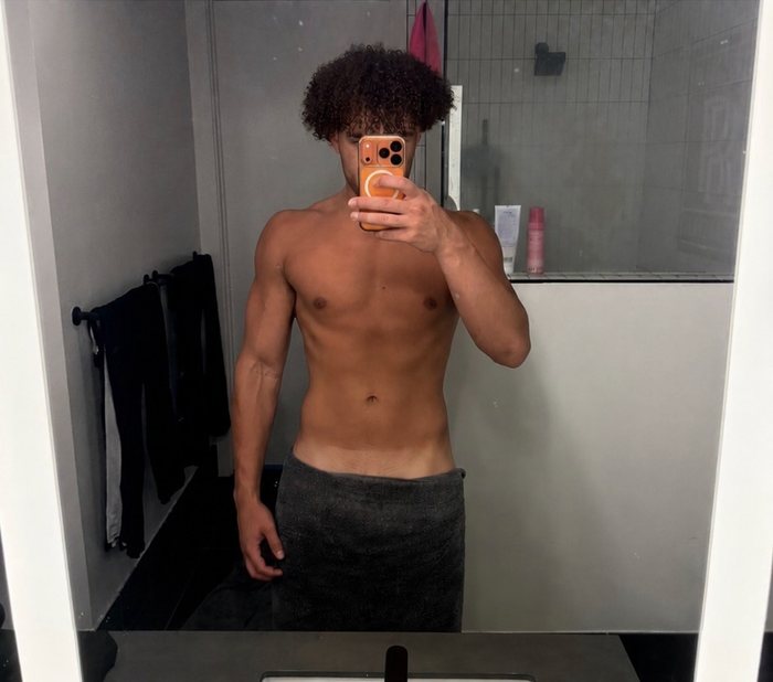 Zay's after photo showing a leaner, more defined physique following the coaching program